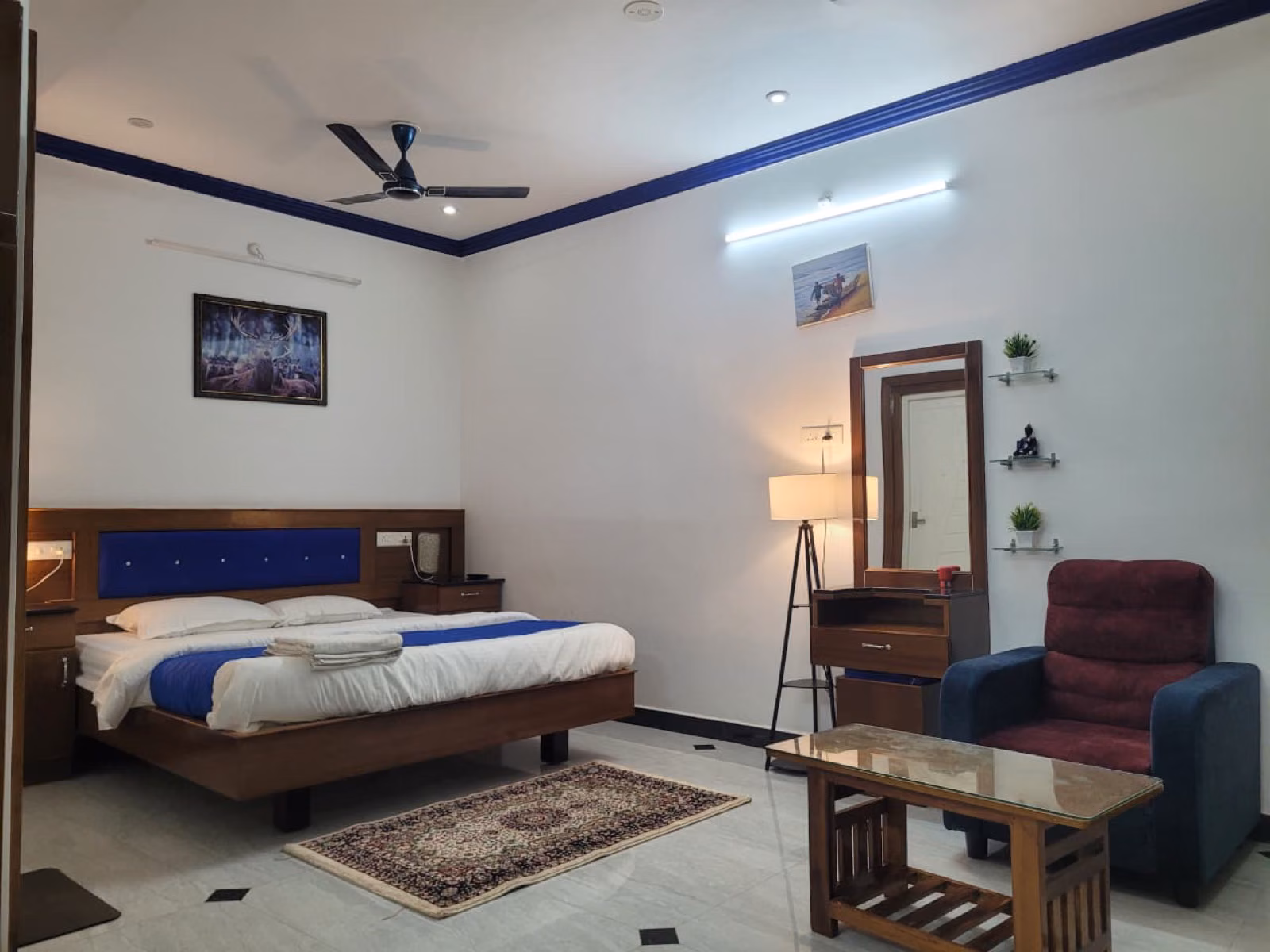 Bedroom suite with king bed, seating area and dresser